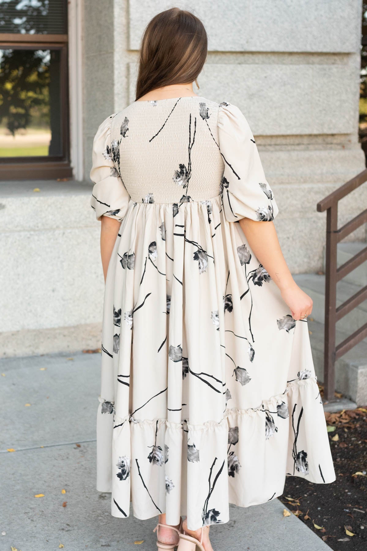 Back view of the beige floral dress with smocked back