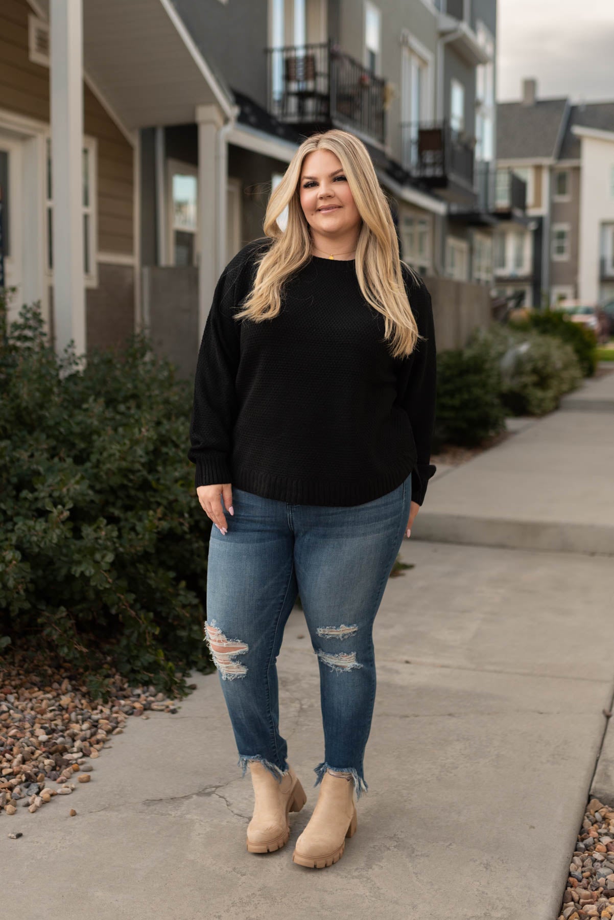 Front view of a plus size black sweater