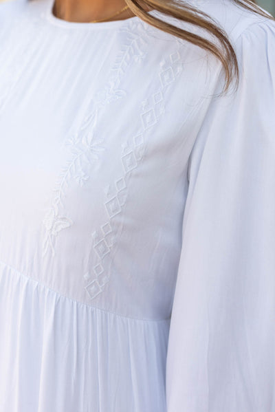 Close up of the embroidery on the bodice on the white embroidered dress