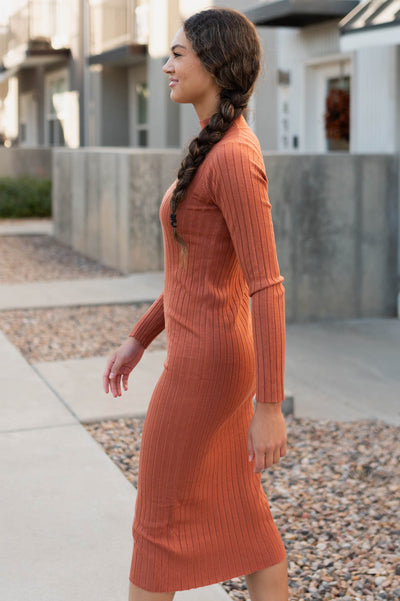 Side view of the rust ribbed sweater dress