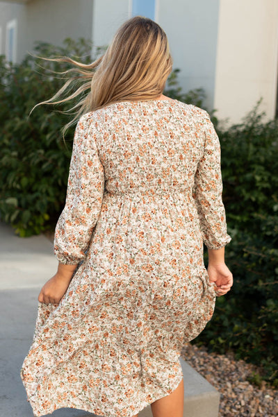 Back view of a taupe floral dress