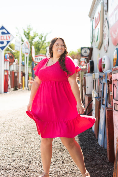 Short sleeve fuchsia dress with a smocked bodice and ruffle at hem