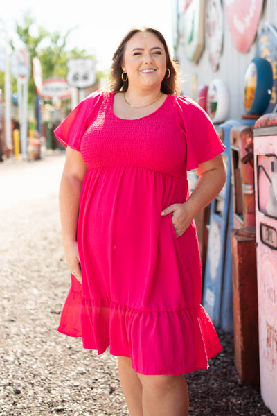 Plus size short sleeve fuchsia dress with a smocked bodice.