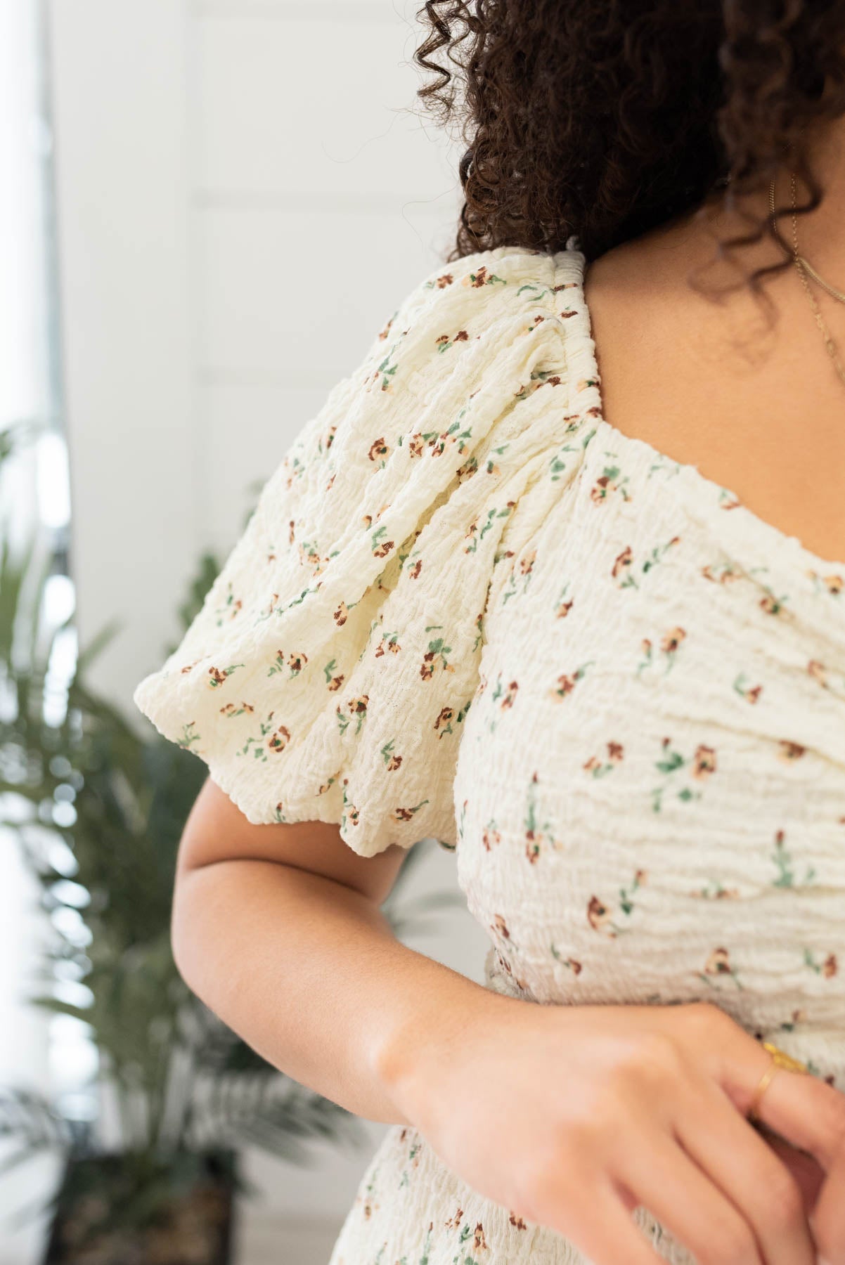 Close up of the sleeve and fabric on the cream floral printed dress