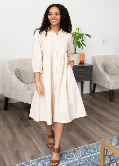 Three quater sleeves on the beige button down dress