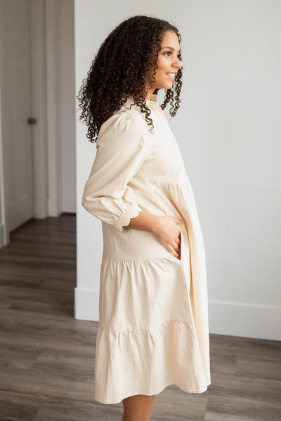 Side view of the beige button down dress