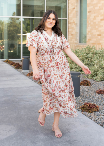 Plus size cream floral tiered dress with lace detail on the bodice