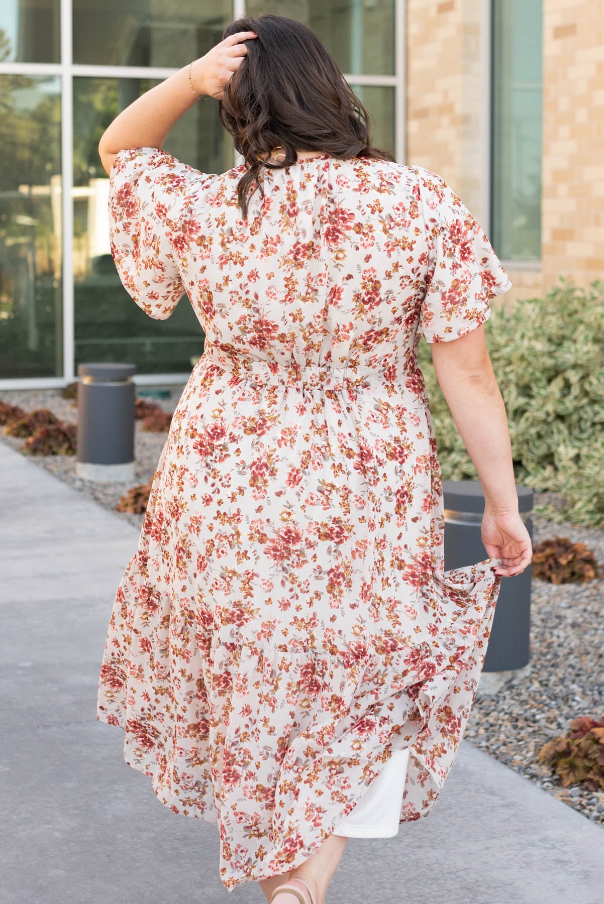 Back view of the cream floral tiered dress in plus size