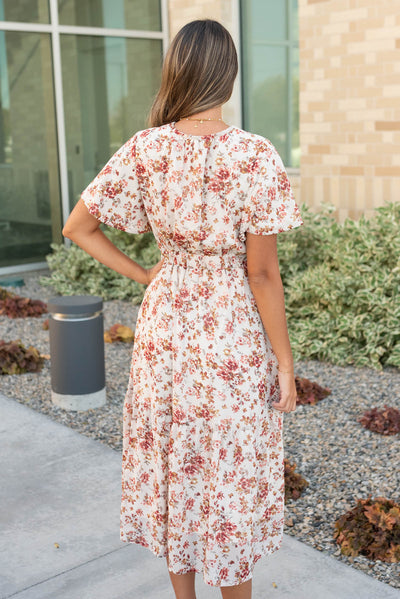 Back view of the cream flroal tiered dress