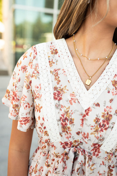 Close up of the bodice on the cream floral tiered dress