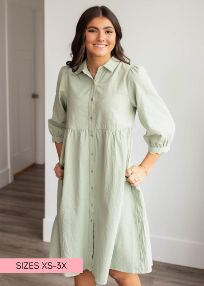 Green button down dress with scalloped cuffs