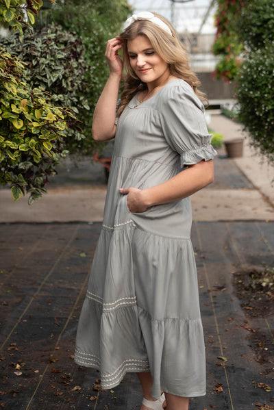 Side view of the cool jade embroidered tiered dress with pockets