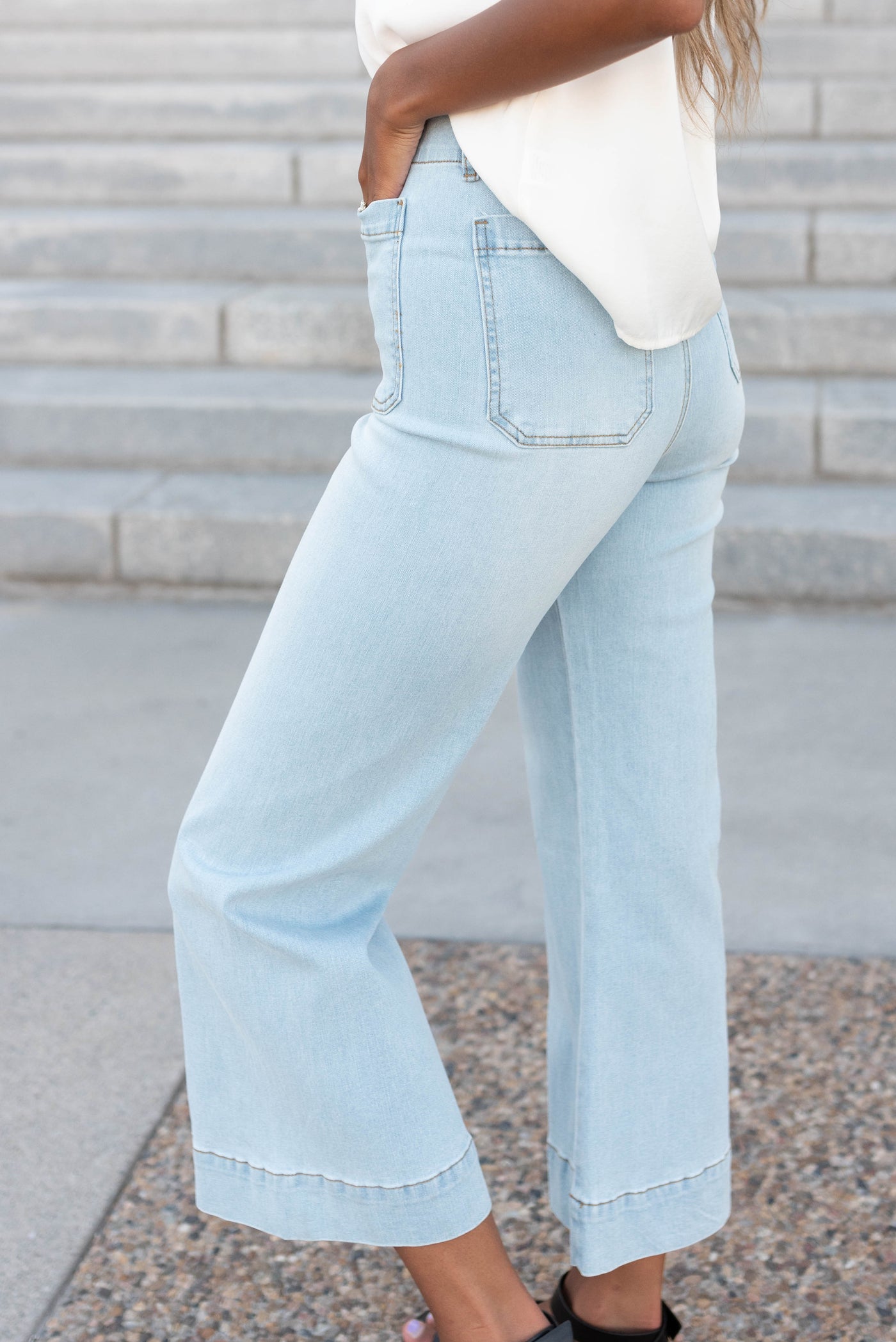 Side view of the light denim wide leg pants