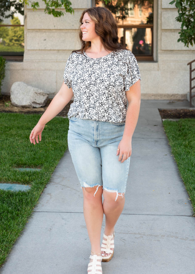 Black floral top with short ruffle sleeves