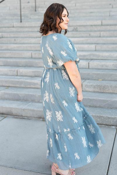 Side view of the plus size dusty blue embroiered dress