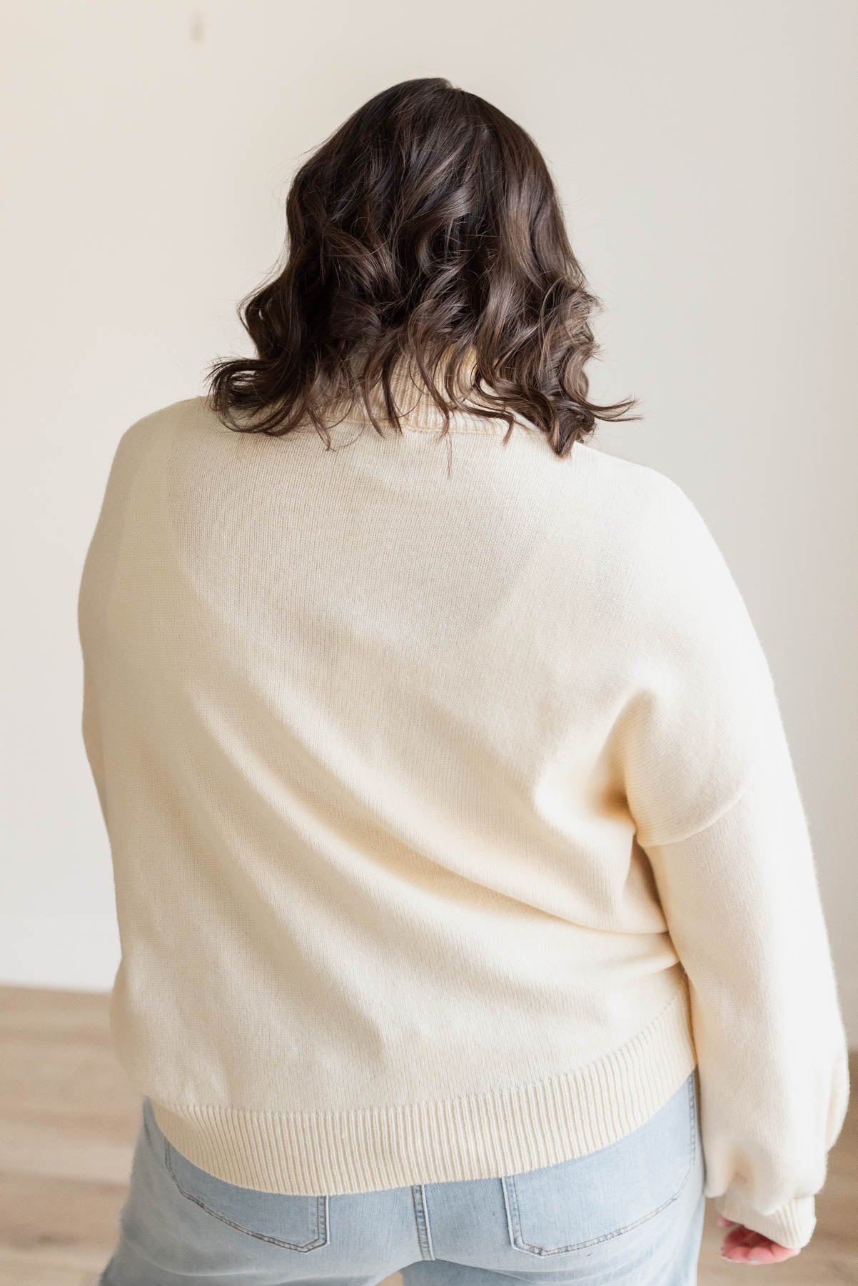 Back view of the plus size red heart cream sweater