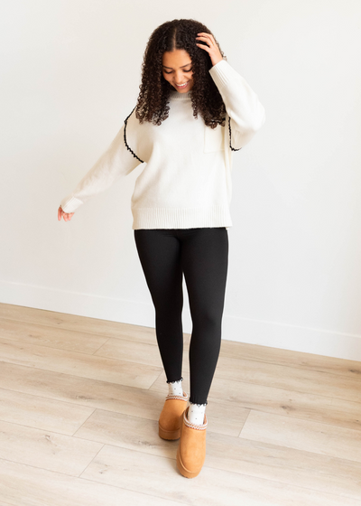 Long sleeve ivory knit sweater with black trim