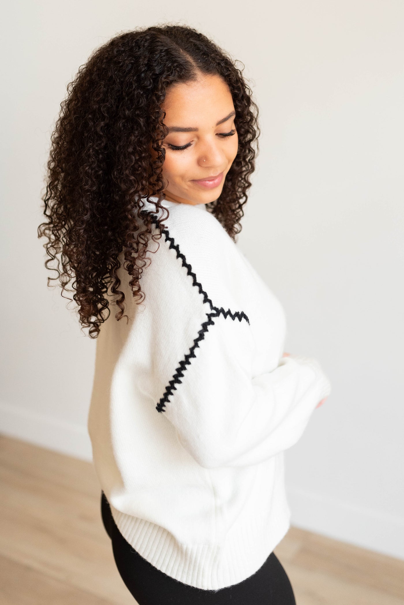 Side view of the ivory knit sweater