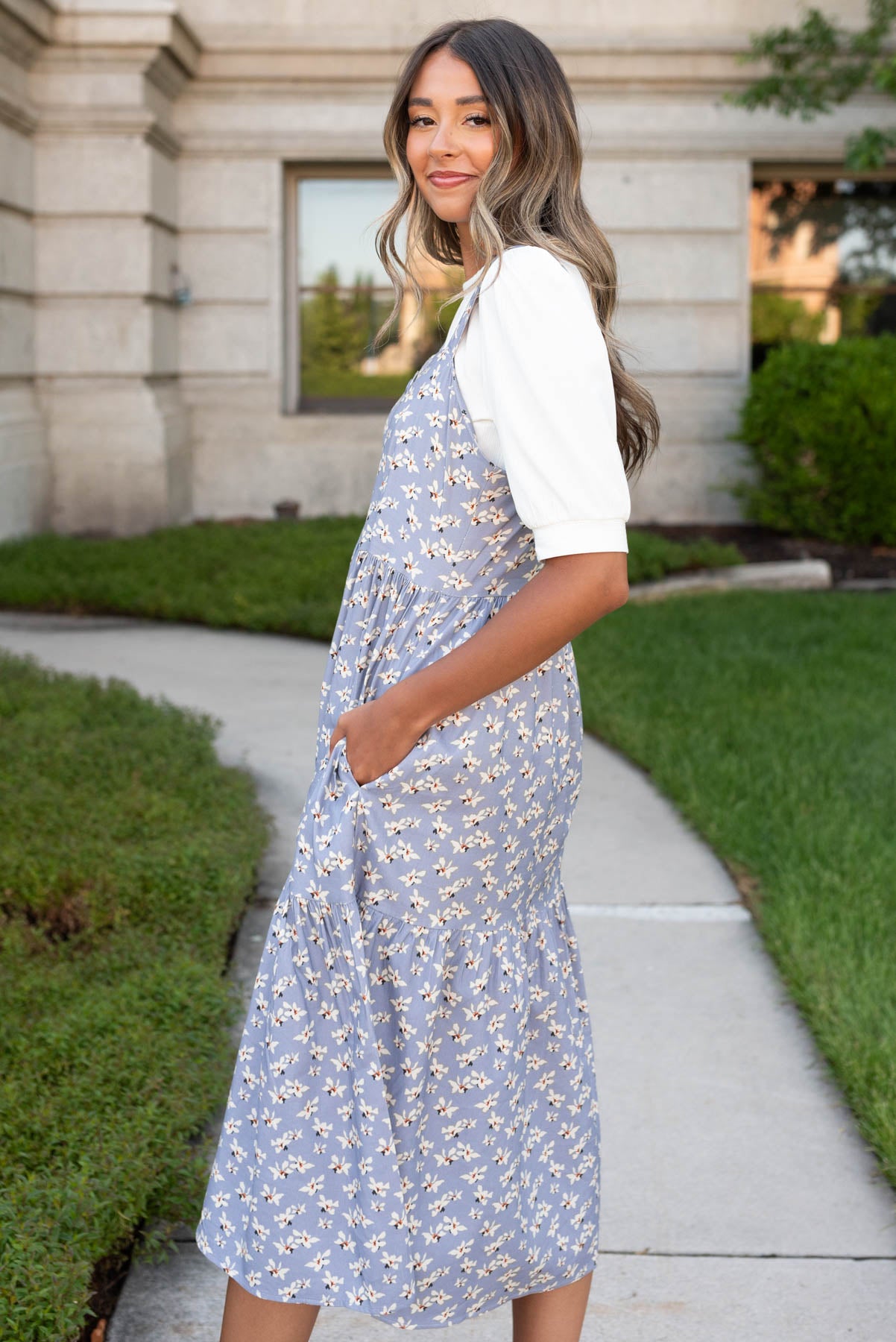 Side view of the blue jumper dress with pockets