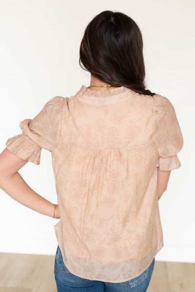 Back view of the taupe floral blouse