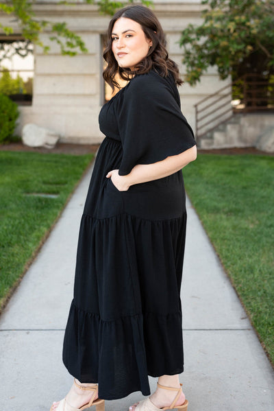 Sie view of the black tiered maxi dress in plus size