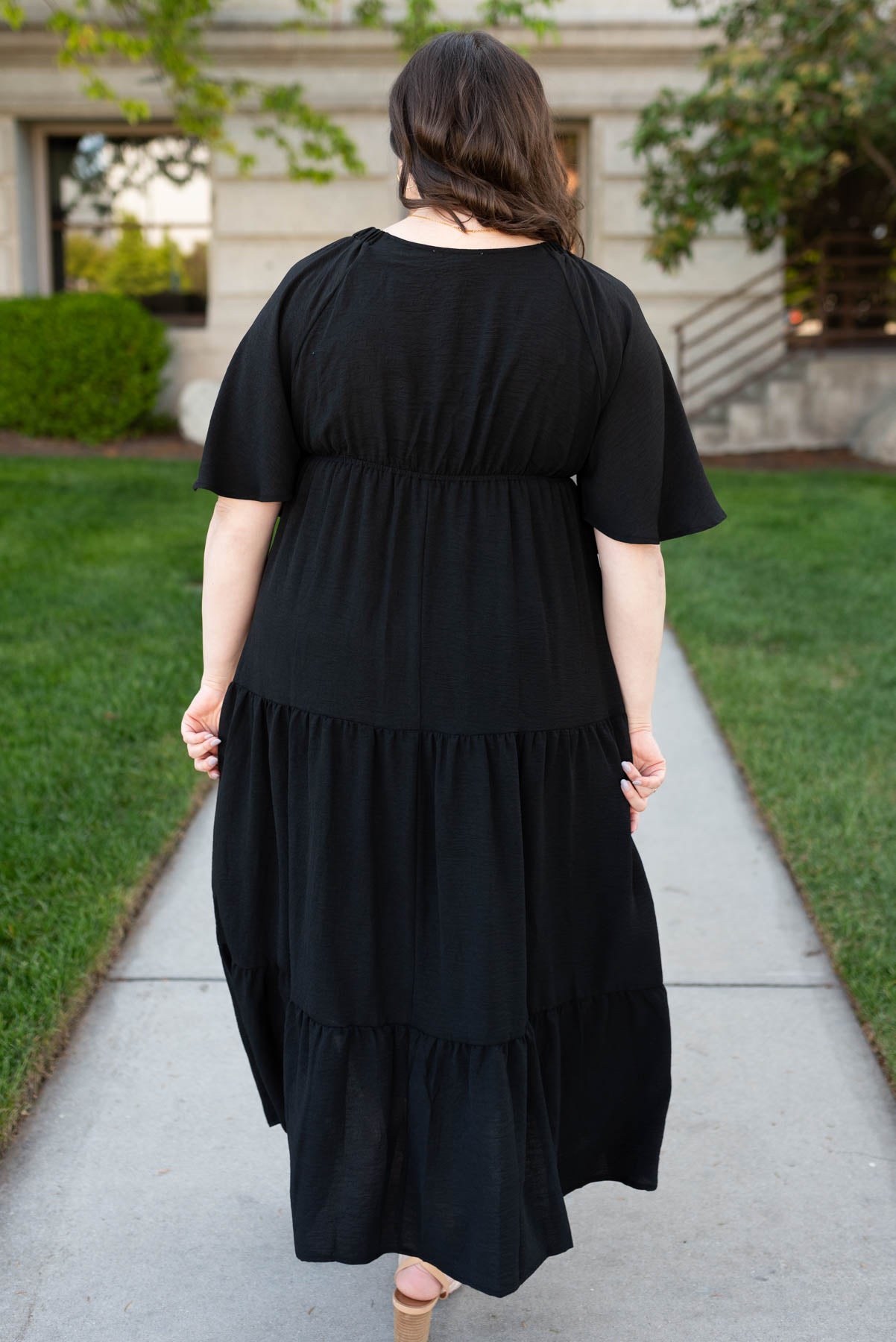 Back view of the plus size black tiered maxi dress