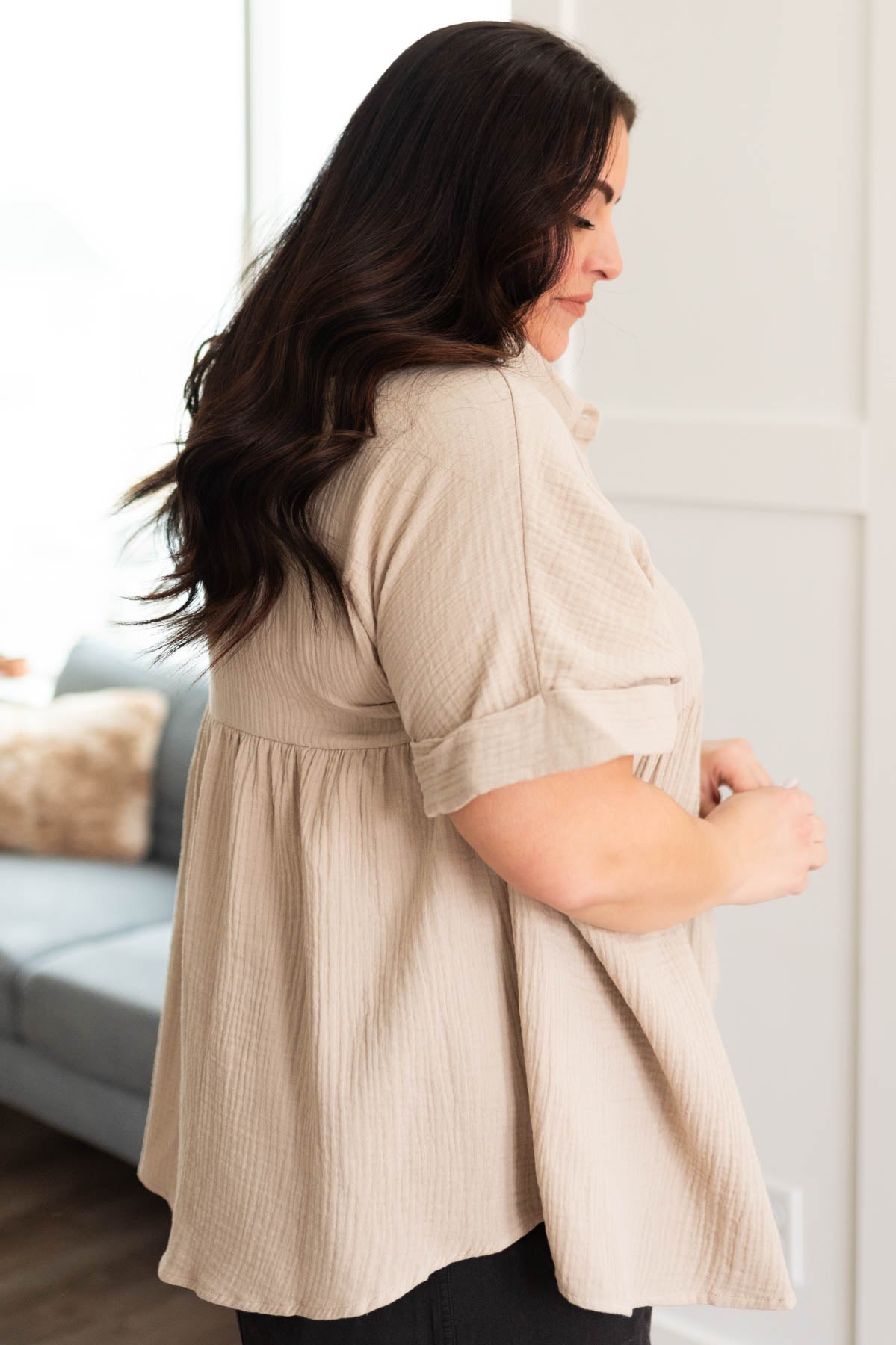 Side view of the taupe button down top