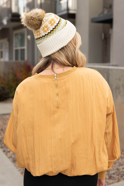 Zipper detail on the mustard parachute blouse