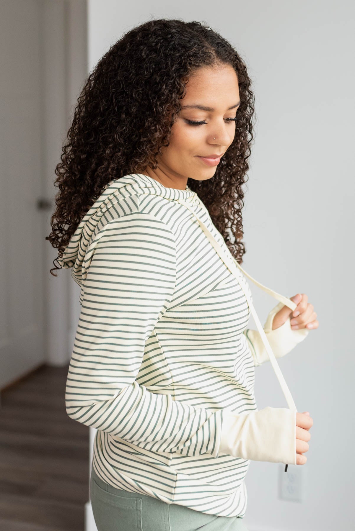 Side view of the green stripe hooded pullover