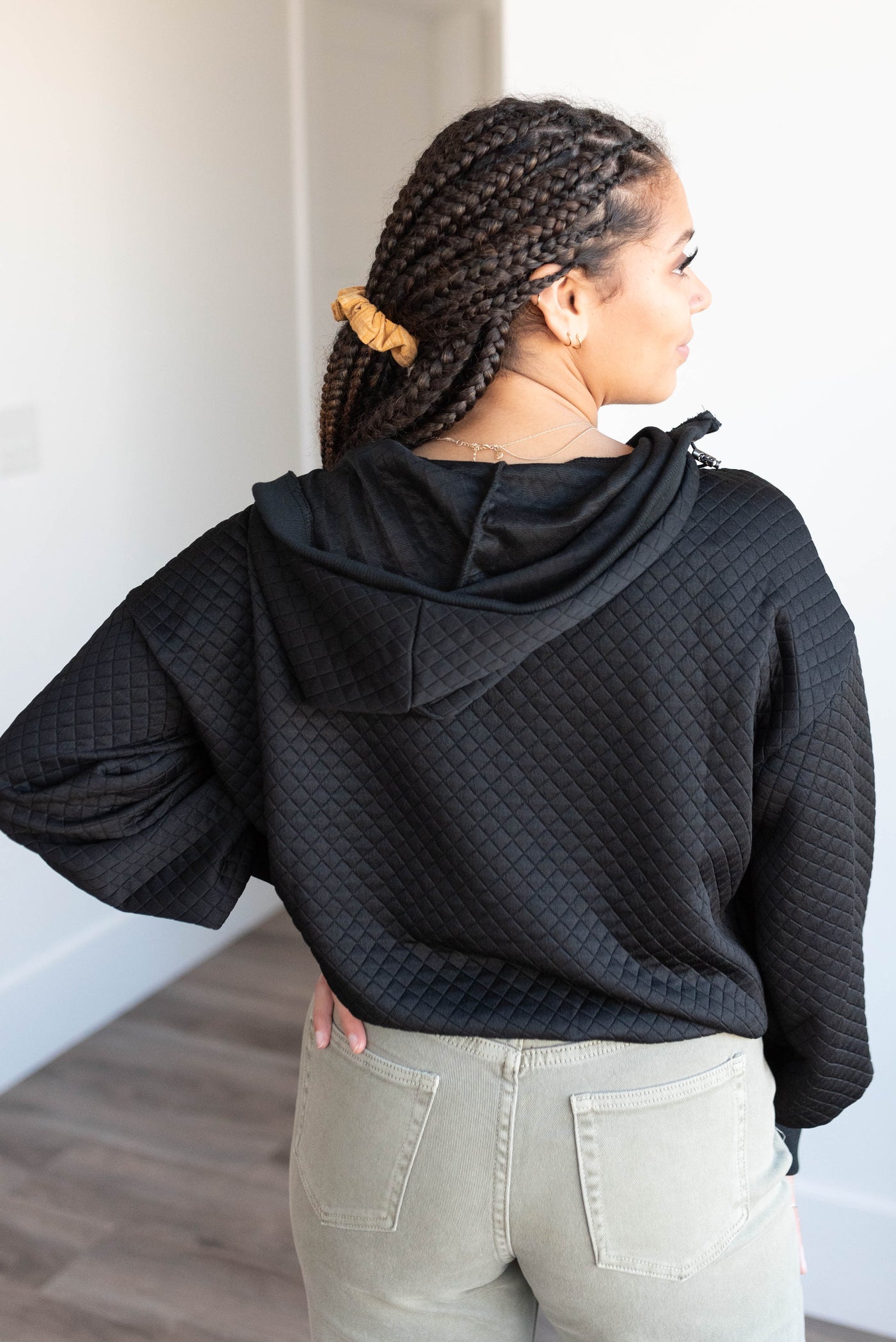 Back view of the black quilted half zip pullover