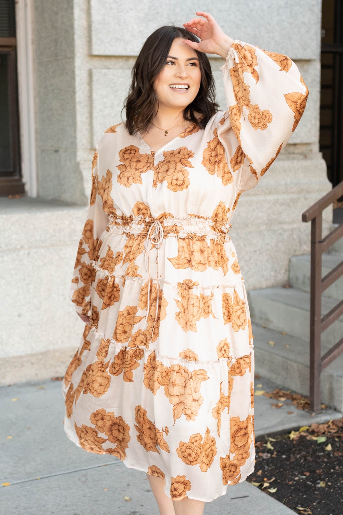 Plus size beige floral dress with a tiered skirt