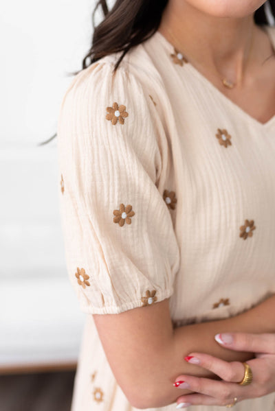 Close up of the fabric and sleeve on the cream embroidered dress