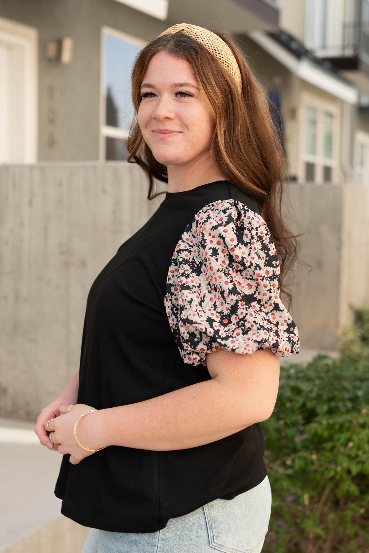 Side view of the black daisy print top