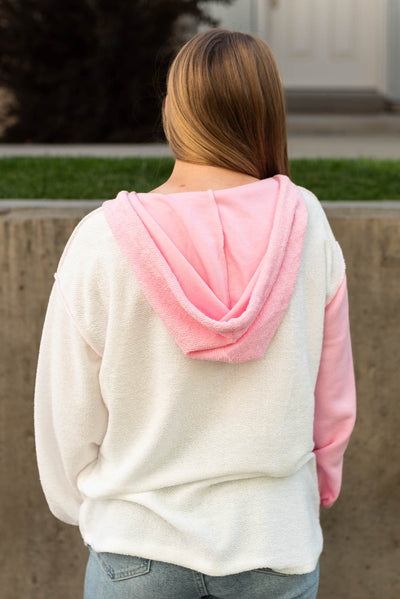 Back view of a pink hoodie