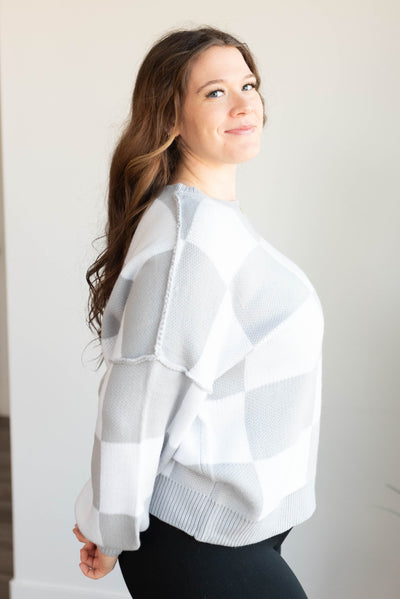 Side view of the grey checkered sweater in plus size