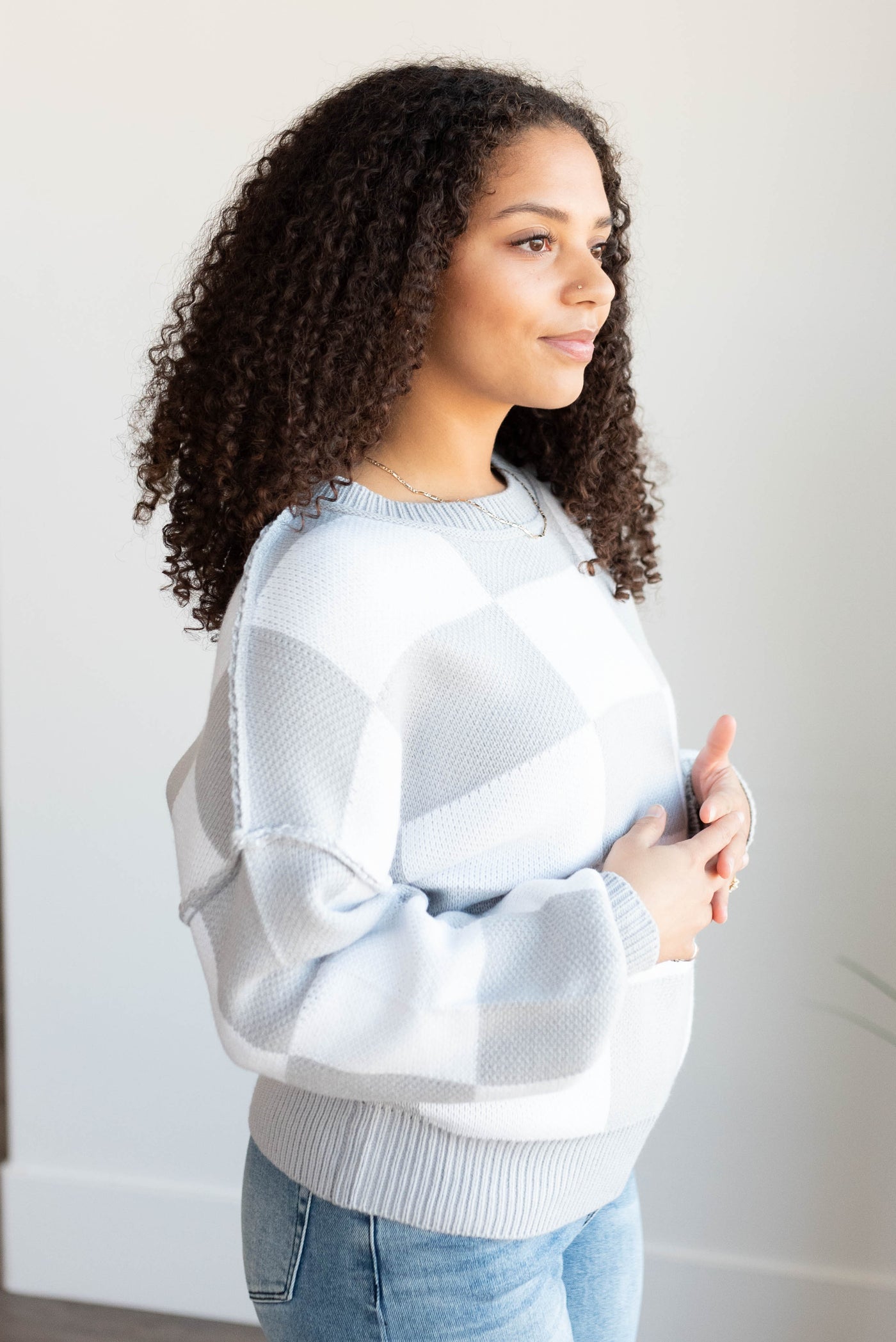 Side view of the grey checkered sweater