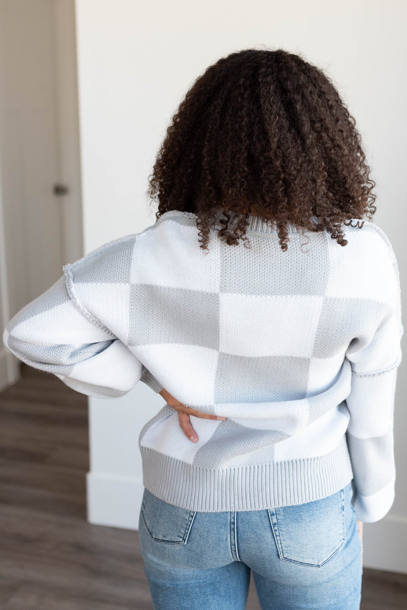 Back view of the grey checkered sweater