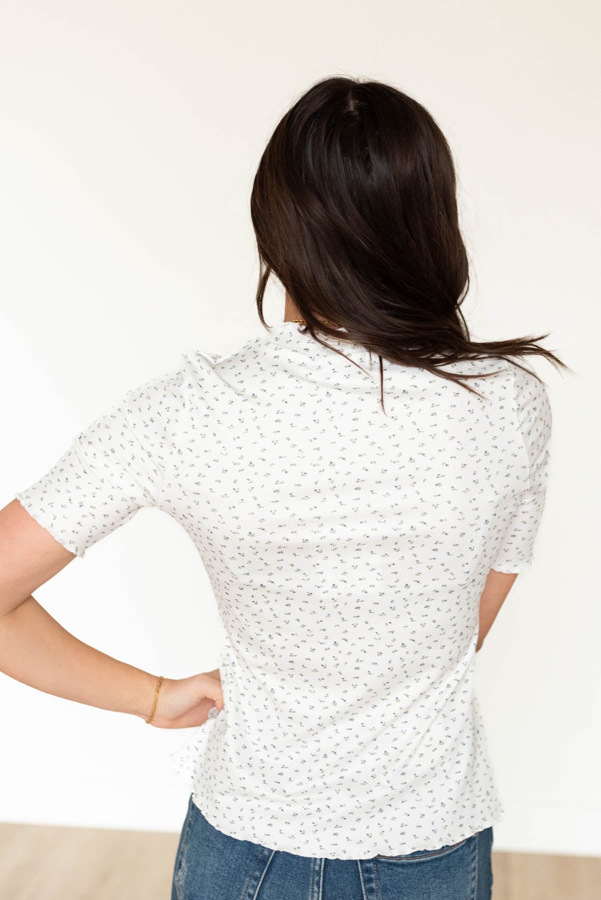 Back view of the the ivory floral ruffle top