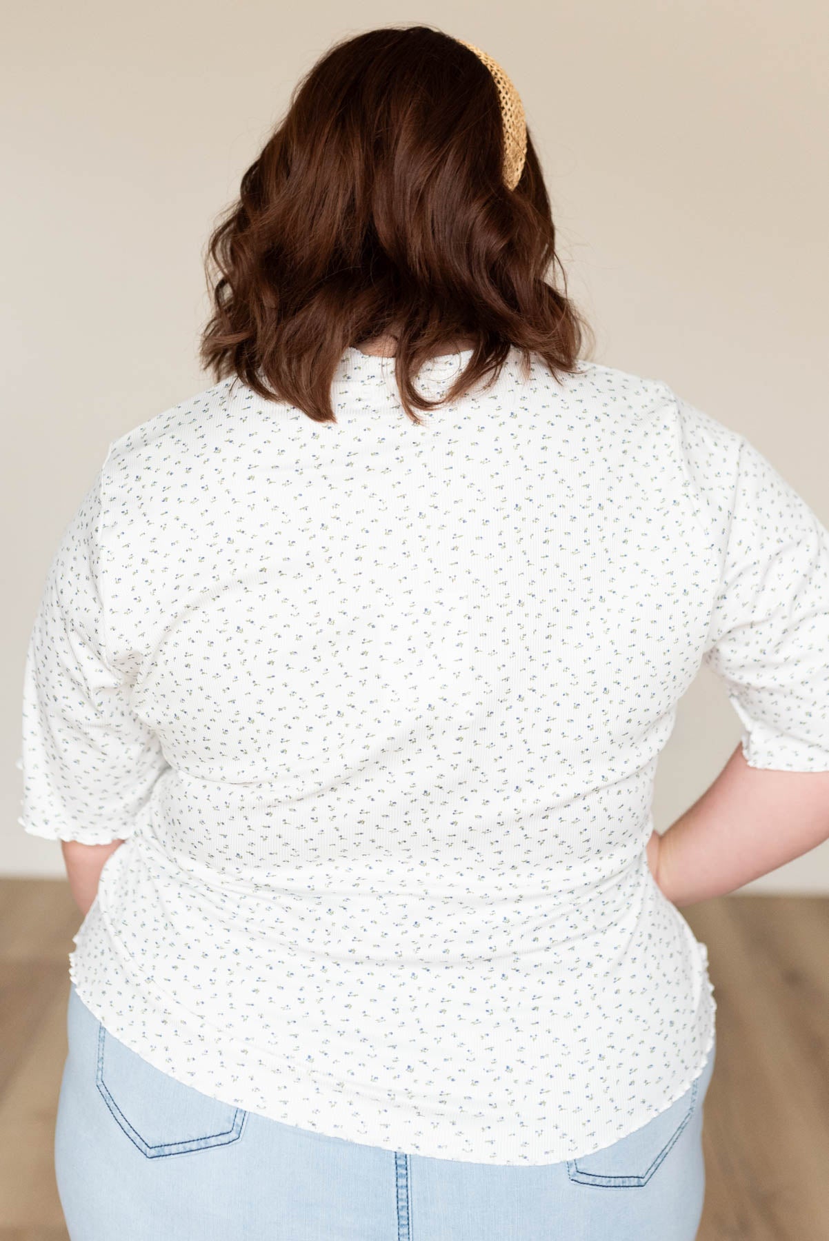 Back view of the plus size ivory floral ruffle top