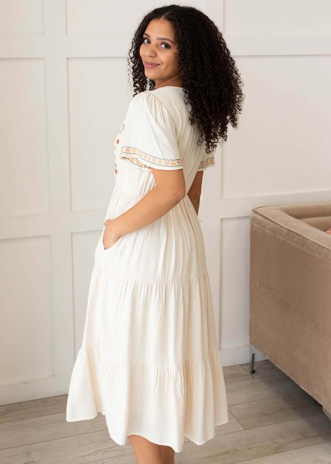 Side view of the ivory embroidered tiered dress