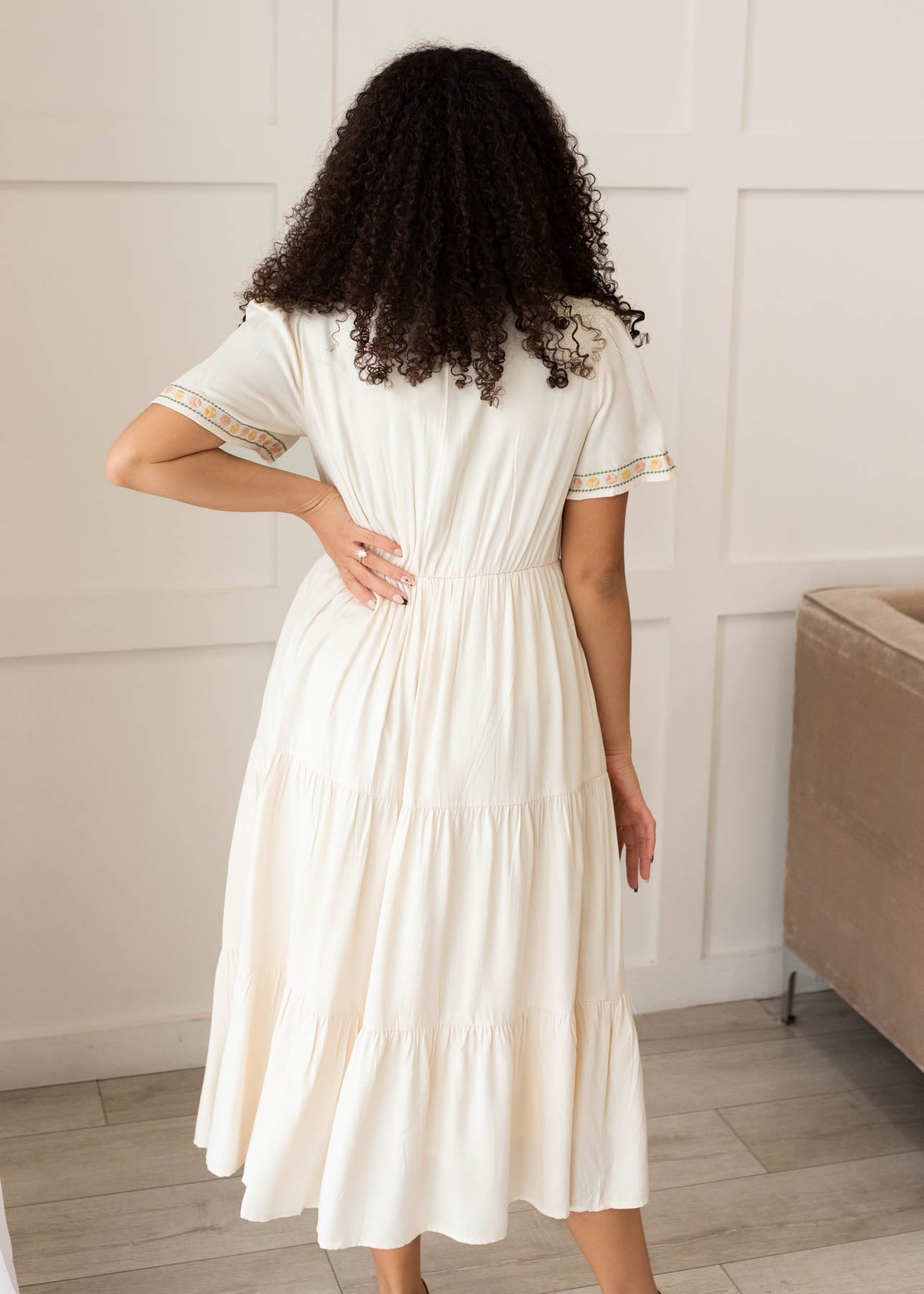 Back view of the ivory embroidered tiered dress