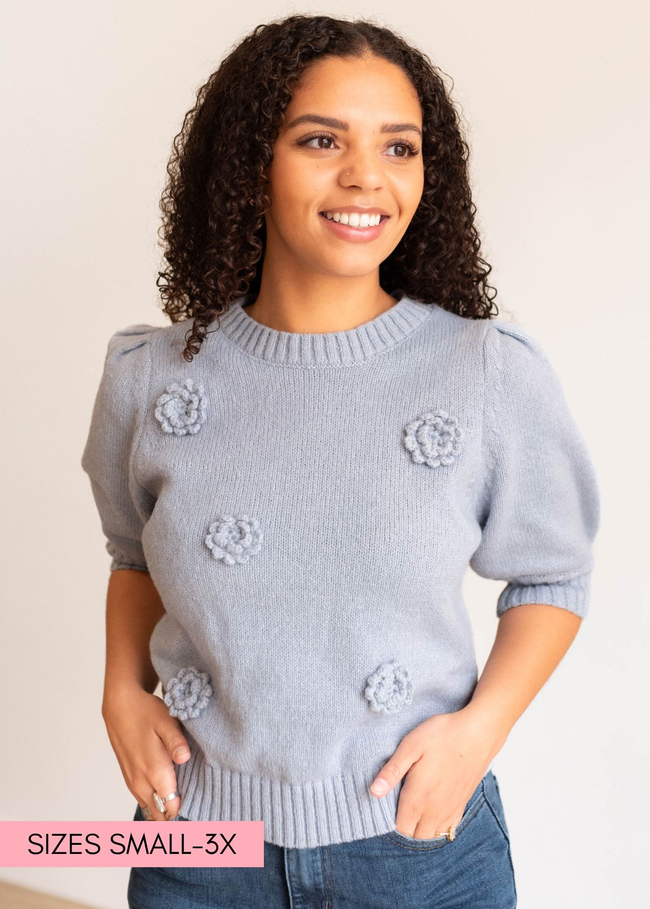 Close up of the flowers on the dusty blue floral knit sweater