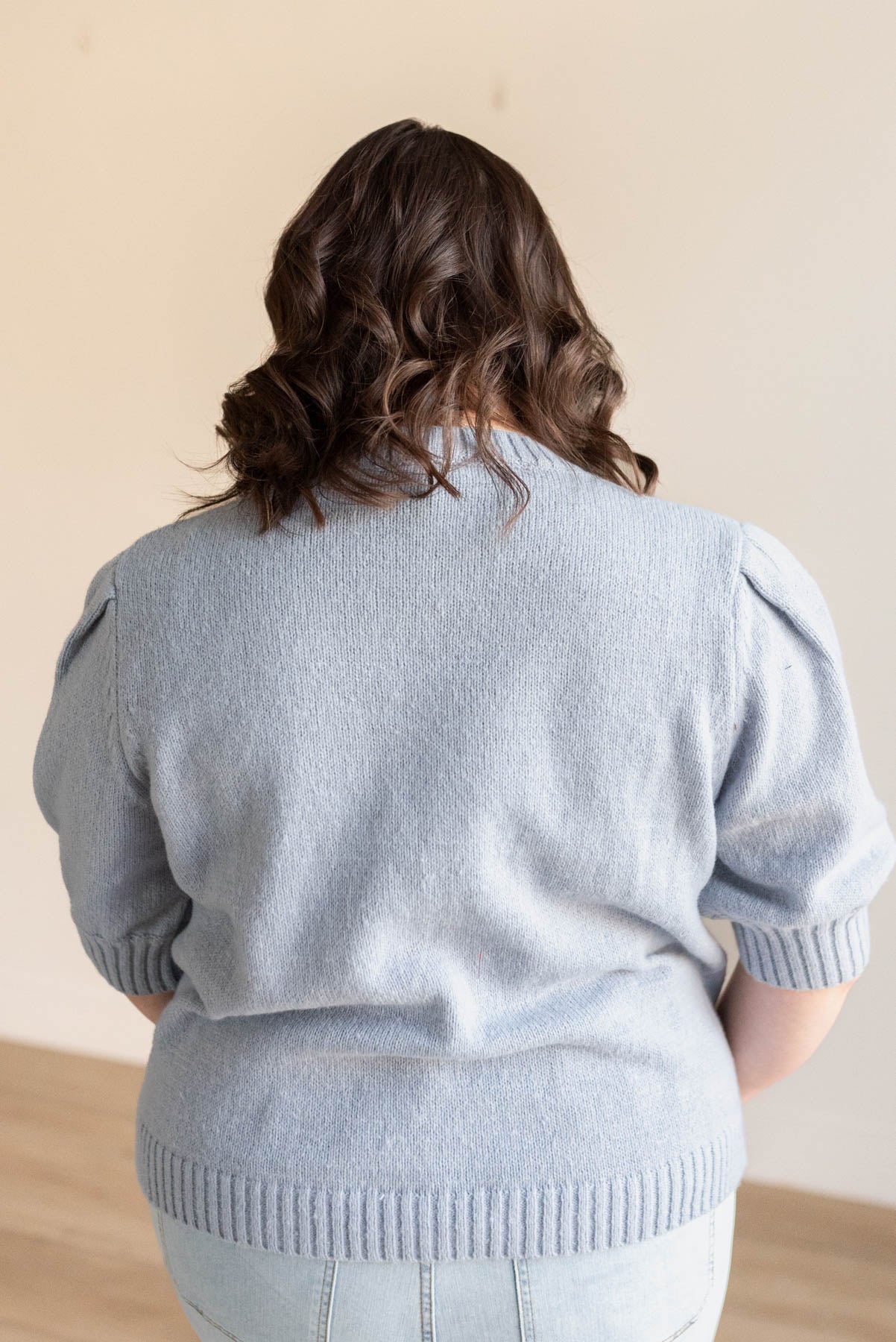 Back view of the plus size dusty blue floral knit sweater