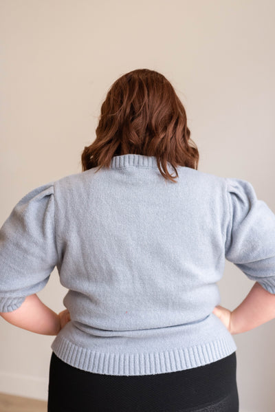 Back view of the plus size dusty blue floral knit sweater