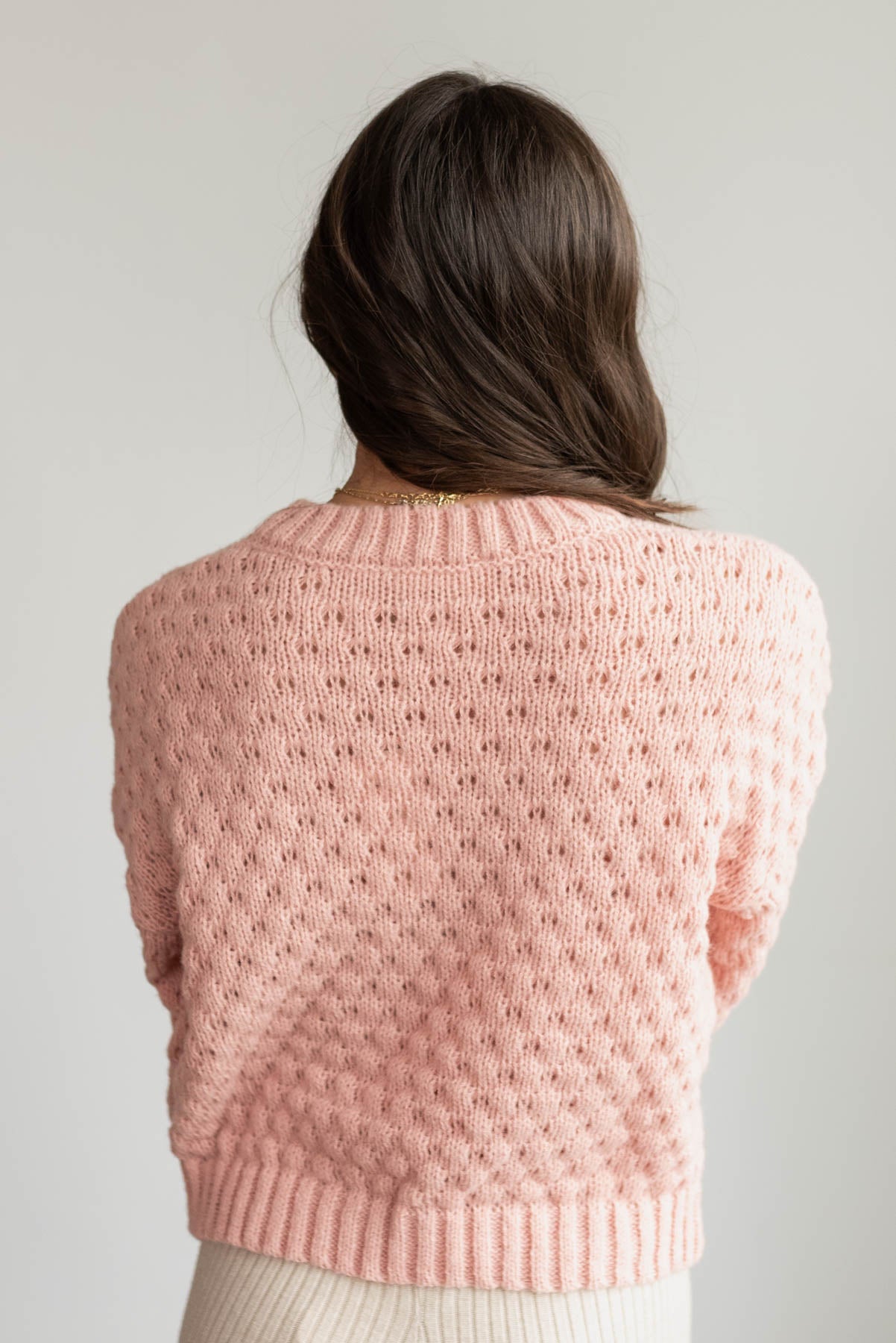 Back view of the blush knit flower sweater