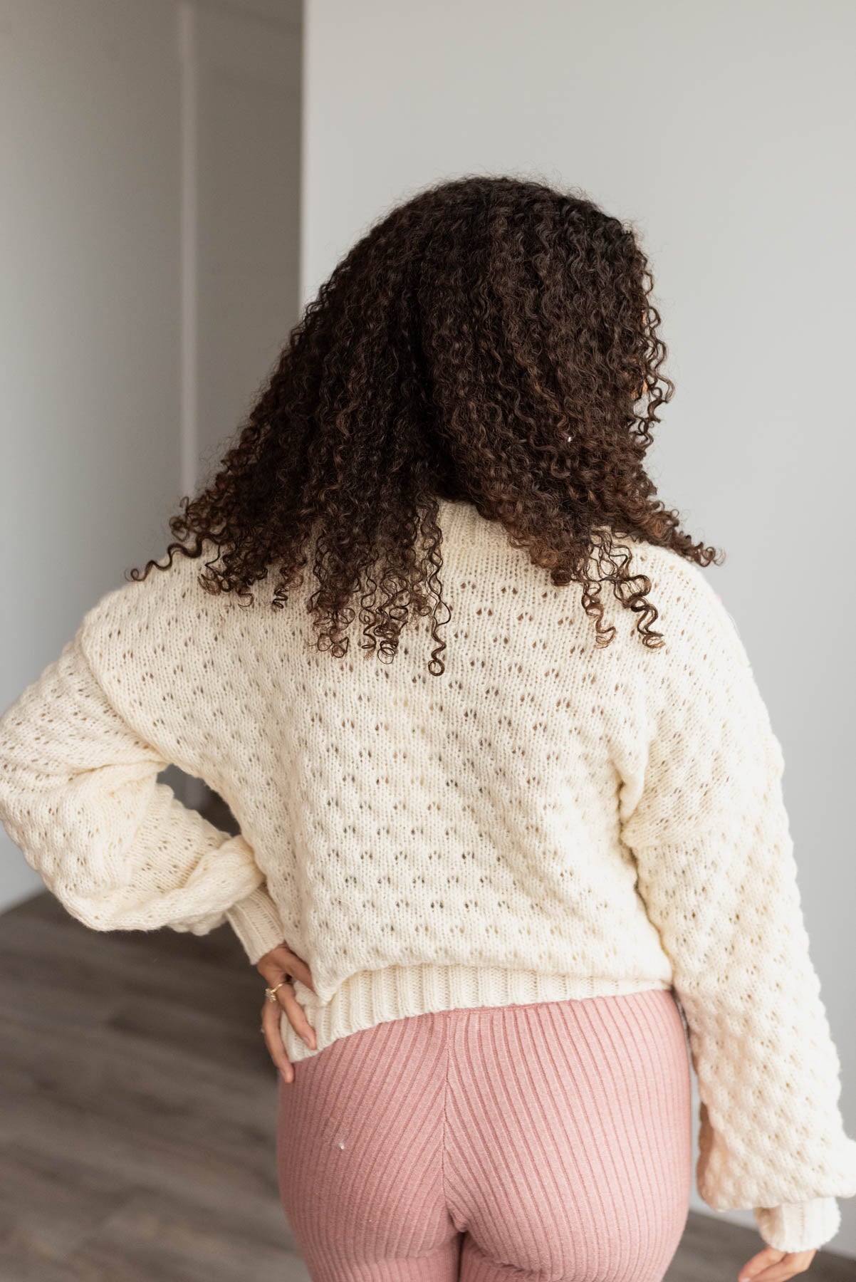 Back view of the cream knit flower sweater