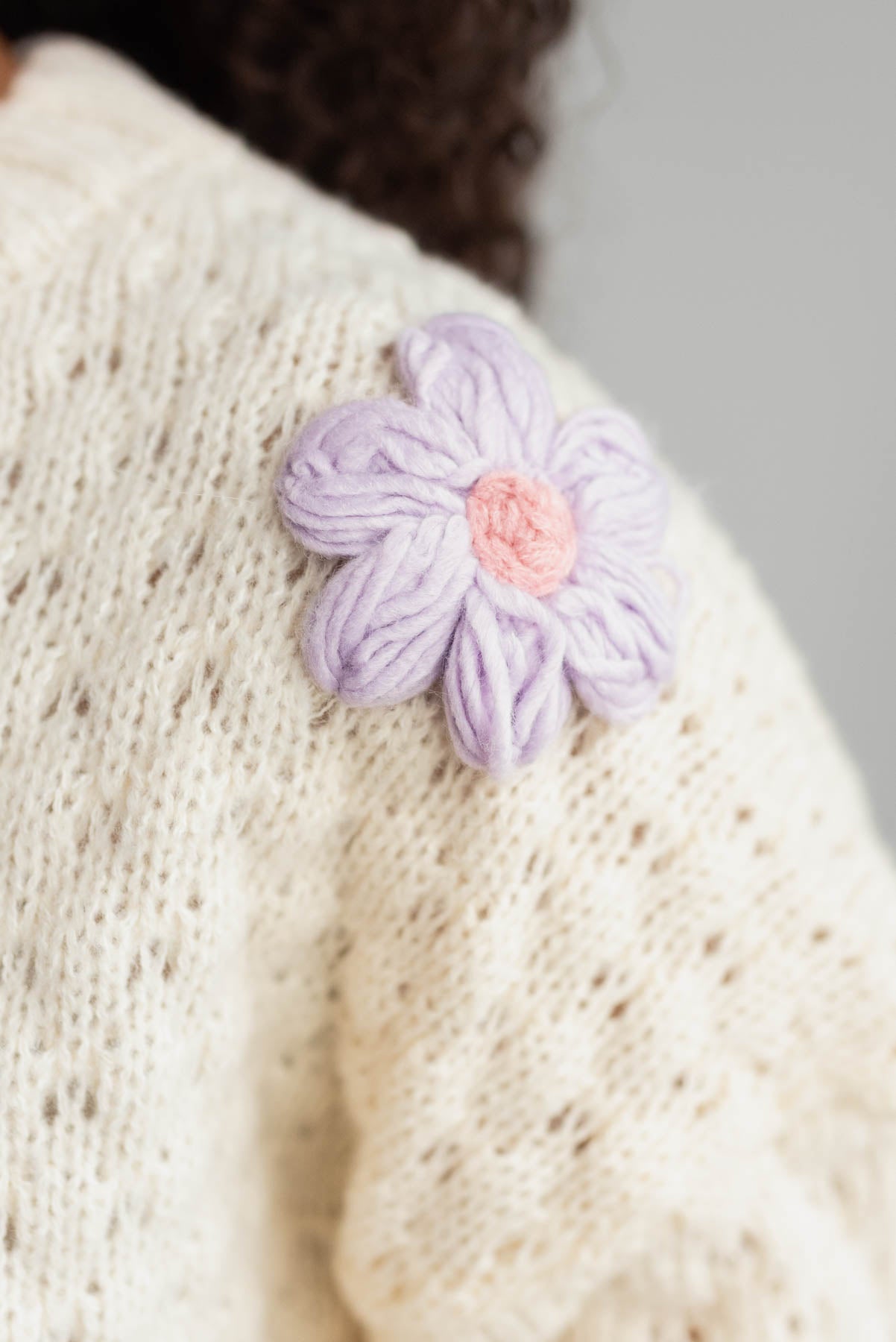 Close up of the flowers on the cream knit flower sweater