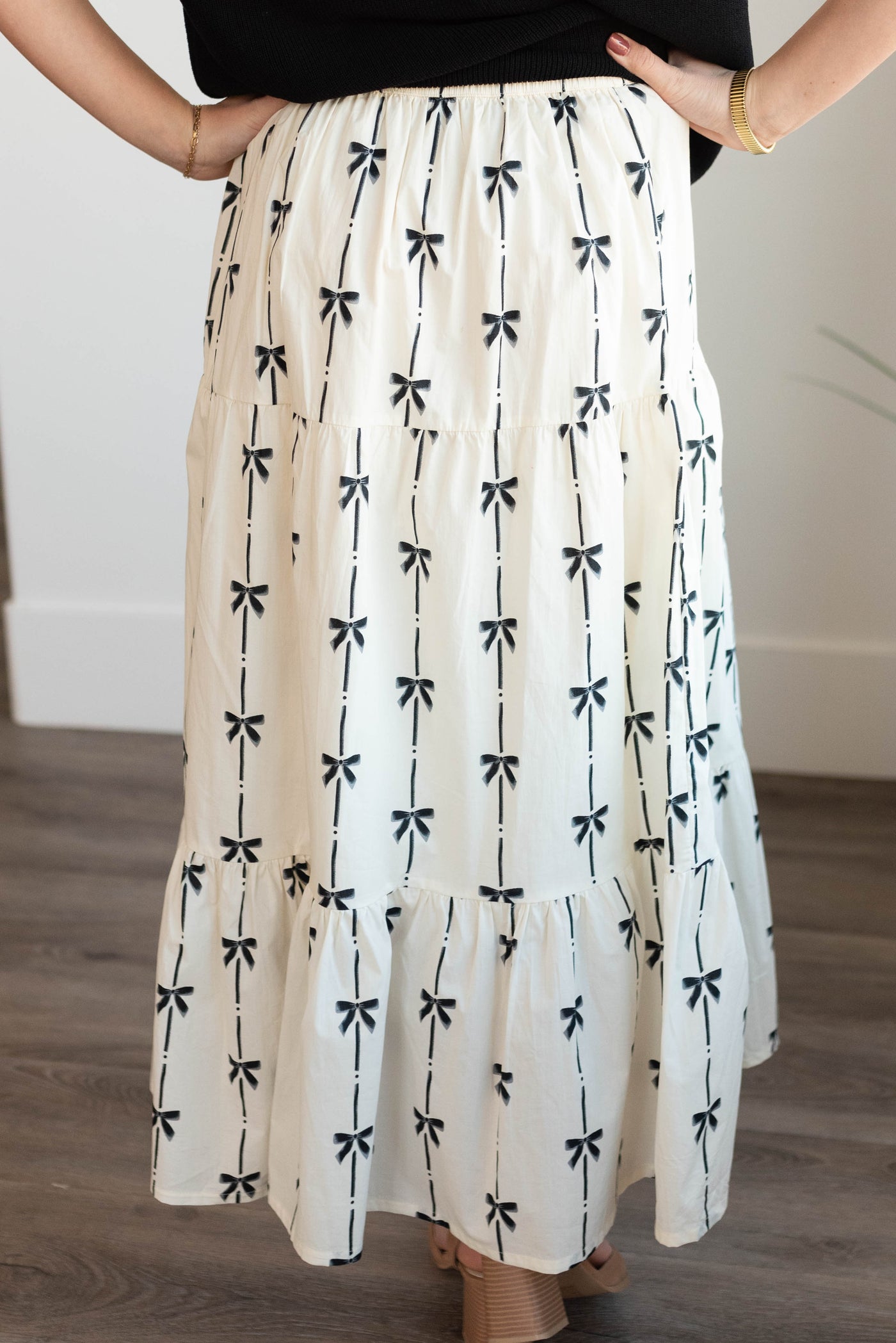 Back view of the ivory bow printed skirt