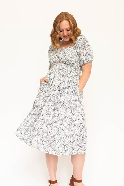 Blue and white short sleeve floral dress with a smocked bodice.