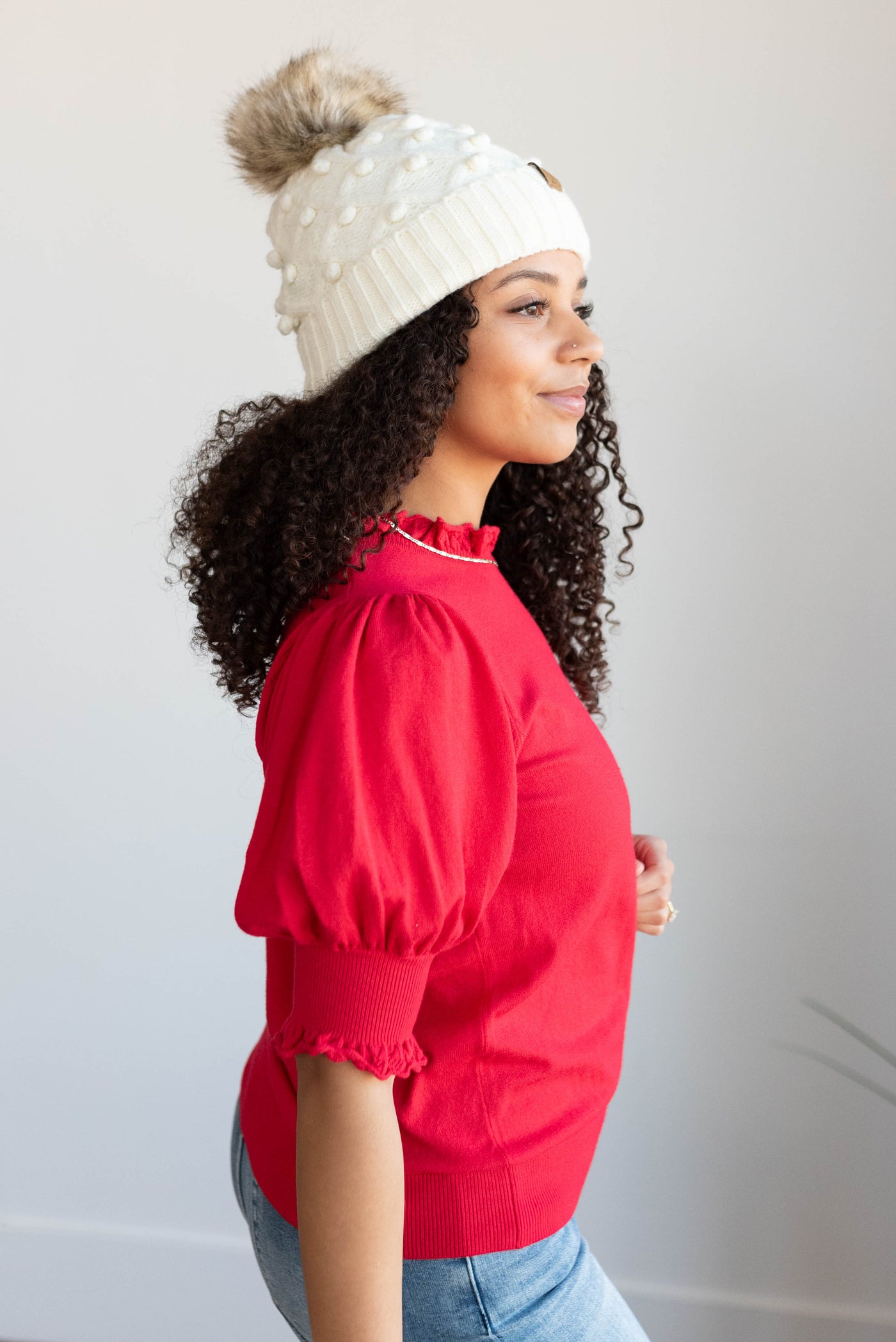 Side view of the red puff sleeve sweater